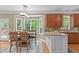 Cozy dining area featuring large windows, stylish light fixture, and view of the outdoor space at 113 Chestone Ct, Cary, NC 27513