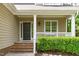 Inviting front porch with classic columns, trim, brick steps, and a view of the landscaped yard at 113 Chestone Ct, Cary, NC 27513