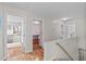 Hallway with hardwood floors and doors to the bedrooms and bathrooms at 113 Chestone Ct, Cary, NC 27513