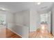 Hallway with hardwood floors and doors leading to bedrooms and bathrooms at 113 Chestone Ct, Cary, NC 27513