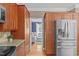 The kitchen features wooden cabinets, stainless steel appliances, and an open doorway to the living room at 113 Chestone Ct, Cary, NC 27513
