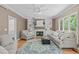 Spacious living room features a fireplace, built-in shelving, and large windows for abundant natural light at 113 Chestone Ct, Cary, NC 27513