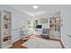Home office with built-in shelves, large desk, and ample natural light at 113 Chestone Ct, Cary, NC 27513
