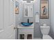 Chic powder room featuring a unique blue glass vessel sink and modern fixtures at 113 Chestone Ct, Cary, NC 27513