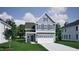 Charming two-story home with a two-car garage, manicured lawn, and beautiful architectural details at 1205 Westerland Way # 25, Durham, NC 27703