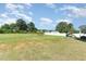 Large, level backyard featuring an open lawn and mature trees with playset and firepit for Gathering fun at 124 Airlie Place Ln, Willow Springs, NC 27592