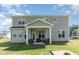 Spacious backyard with a covered patio, outdoor seating, and a sandbox play area at 124 Airlie Place Ln, Willow Springs, NC 27592
