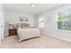 Sunlit bedroom with neutral tones, featuring two windows and a comfortable bed at 124 Airlie Place Ln, Willow Springs, NC 27592