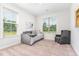 Bright bedroom with neutral tones, two windows, and comfortable furniture at 124 Airlie Place Ln, Willow Springs, NC 27592