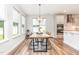 Bright dining area connected to the kitchen, featuring stylish lighting at 124 Airlie Place Ln, Willow Springs, NC 27592