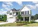 Charming two-story home featuring a welcoming front porch and manicured landscaping at 124 Airlie Place Ln, Willow Springs, NC 27592