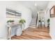 Bright foyer with hardwood floors, staircase, and console table creates a welcoming entry at 124 Airlie Place Ln, Willow Springs, NC 27592