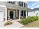 Inviting home entrance featuring a covered front porch with columns and stylish landscaping at 124 Airlie Place Ln, Willow Springs, NC 27592