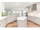 Bright, open kitchen featuring white cabinetry, stainless steel appliances, and a center island at 124 Airlie Place Ln, Willow Springs, NC 27592