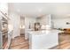 Modern kitchen features white cabinetry, a quartz island, and stainless steel appliances at 124 Airlie Place Ln, Willow Springs, NC 27592