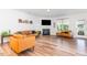 Comfortable living room featuring a fireplace, large TV, and leather seating at 124 Airlie Place Ln, Willow Springs, NC 27592