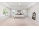 Large bedroom featuring a tray ceiling, carpet, and decorative mirror at 124 Airlie Place Ln, Willow Springs, NC 27592