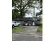 Gray home with a basketball hoop and swing, surrounded by greenery and vehicles at 12600 Old Stage Rd, Willow Springs, NC 27592