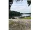 Picturesque view of a serene lake featuring a wooden dock on a clear day at 12600 Old Stage Rd, Willow Springs, NC 27592