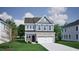 Charming two-story home showcasing stone accents and a welcoming entrance, set on a lush green lawn at 1307 Westerland Way # 16, Durham, NC 27703
