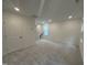 Bright bonus room with plush carpeting, recessed lighting, and a staircase leading to the next level at 1532 Crescent Townes Way, Raleigh, NC 27604