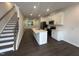 Well-lit kitchen featuring stainless appliances, a center island and sleek white cabinetry at 1532 Crescent Townes Way, Raleigh, NC 27604