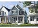 Charming blue two-story home with inviting front porch and well-manicured lawn at 1537 Piney Fls Dr, Wendell, NC 27591