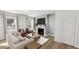 Cozy living room with fireplace, large windows, and comfortable seating area at 1537 Piney Fls Dr, Wendell, NC 27591