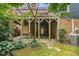 Backyard with a covered deck, garden area, and mature landscaping at 1547 Village Glenn Dr, Raleigh, NC 27612