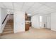 Finished basement features stairs, kitchenette, and doorway to a bathroom at 1547 Village Glenn Dr, Raleigh, NC 27612