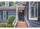 Inviting front entrance featuring a brick staircase and a dark-colored front door at 1547 Village Glenn Dr, Raleigh, NC 27612