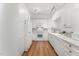 Stylish kitchen featuring white cabinets, stainless steel appliances, and hardwood floors at 1547 Village Glenn Dr, Raleigh, NC 27612