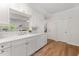 Bright kitchen featuring white cabinets, quartz countertops, and hardwood floors at 1547 Village Glenn Dr, Raleigh, NC 27612