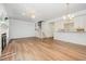 Spacious open-concept living room with hardwood floors and a fireplace at 1547 Village Glenn Dr, Raleigh, NC 27612