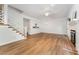 Cozy living room featuring hardwood floors, a fireplace, and access to the kitchen at 1547 Village Glenn Dr, Raleigh, NC 27612