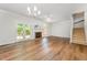 Bright living room featuring hardwood floors, a fireplace, and access to the back deck at 1547 Village Glenn Dr, Raleigh, NC 27612