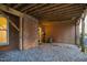 Covered back patio has gravel floor and brick wall at 1547 Village Glenn Dr, Raleigh, NC 27612