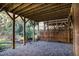 View under deck showing support structure and stone ground cover at 1547 Village Glenn Dr, Raleigh, NC 27612