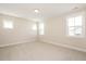 A carpeted bedroom with natural light and large windows at 1601 Merry Mdw Way, Wendell, NC 27591