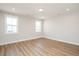 This is a large empty bedroom with hardwood floors and lots of natural light at 1601 Merry Mdw Way, Wendell, NC 27591