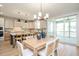 Dining area with a wood table, neutral chairs, and sliding glass doors to the outdoor patio at 1601 Merry Mdw Way, Wendell, NC 27591