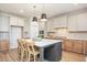 Bright kitchen with a center island, modern lighting, and stainless steel appliances at 1601 Merry Mdw Way, Wendell, NC 27591