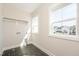 Sunlit laundry room with tile flooring, shelving, and a window at 1601 Merry Mdw Way, Wendell, NC 27591