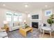 Bright living room with fireplace, large windows, and stylish furnishings on an area rug at 1601 Merry Mdw Way, Wendell, NC 27591