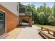 Brick home with patio, picnic table, and grassy yard with mature trees at 1909 Ira Rd, Efland, NC 27243