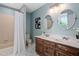 Well-lit bathroom with double sinks, a combination tub and shower, and modern finishes at 1909 Ira Rd, Efland, NC 27243