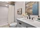 This bathroom has neutral paint, a white vanity with a marble countertop, and a glass shower at 1909 Ira Rd, Efland, NC 27243