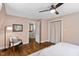 This bedroom has wood floors, a ceiling fan and a closet with a beige curtain at 1909 Ira Rd, Efland, NC 27243