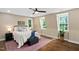 Comfortable bedroom featuring hardwood floors, a ceiling fan, area rug and plenty of natural light at 1909 Ira Rd, Efland, NC 27243