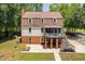 Two-story home featuring a screened-in porch, brick accents, and backyard at 1909 Ira Rd, Efland, NC 27243